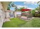 Backyard featuring a wood deck, synthetic grass, and convenient access to the air conditioning unit at 4406 W Harbor View Ave, Tampa, FL 33611