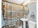 Quaint bathroom with neutral colors and inspirational messages on the shower curtain at 4406 W Harbor View Ave, Tampa, FL 33611