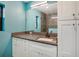 Bright bathroom with white cabinets, granite counters, and a large mirror and shower at 4406 W Harbor View Ave, Tampa, FL 33611