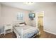 Cozy bedroom with modern accents, wood floors, and a comfortable bed at 4406 W Harbor View Ave, Tampa, FL 33611