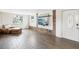 Bright living room features wood-look floors, a comfy chair, and a mounted TV for relaxation at 4406 W Harbor View Ave, Tampa, FL 33611