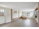 Cozy living room boasts brick accents, wood-look floors, and a comfortable leather chair at 4406 W Harbor View Ave, Tampa, FL 33611