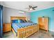 Well-lit main bedroom with a ceiling fan, polished concrete floors, and complementary furnishings at 4406 W Harbor View Ave, Tampa, FL 33611