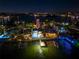 An aerial view of waterfront home at night showcasing backyard pool and private dock at 474 20Th Ave, Indian Rocks Beach, FL 33785