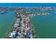 Aerial view of waterfront homes on canals with boats and a view of the ocean at 474 20Th Ave, Indian Rocks Beach, FL 33785