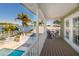 Balcony view showcasing outdoor seating, mature palm trees, and waterfront at 474 20Th Ave, Indian Rocks Beach, FL 33785