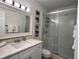 Bright bathroom with updated vanity, quartz countertop, and a walk-in shower with glass doors at 474 20Th Ave, Indian Rocks Beach, FL 33785
