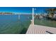 View of private dock and waterfront, with calm water and clear blue sky at 474 20Th Ave, Indian Rocks Beach, FL 33785