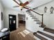 Bright foyer with staircase, modern flooring, and nautical decor provides a welcoming entrance to the home at 474 20Th Ave, Indian Rocks Beach, FL 33785