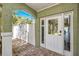 Charming front entrance with brick walkway and decorative glass door at 474 20Th Ave, Indian Rocks Beach, FL 33785