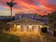 Charming waterfront home with a two-car garage, lush landscaping, and a paver driveway at 474 20Th Ave, Indian Rocks Beach, FL 33785