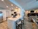 Open kitchen featuring stainless steel appliances, a breakfast bar, and a view of the living area at 474 20Th Ave, Indian Rocks Beach, FL 33785