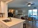 Open-concept kitchen with a breakfast bar, flowing into the living and dining areas with water views at 474 20Th Ave, Indian Rocks Beach, FL 33785