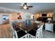 Open-concept living room features a dining area, kitchen, and comfortable seating around a brick fireplace at 474 20Th Ave, Indian Rocks Beach, FL 33785