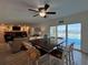 Open-concept living room featuring stylish furniture and an exit door to the outdoor pool and waterfront at 474 20Th Ave, Indian Rocks Beach, FL 33785
