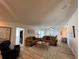 Open-concept living area features modern furniture, an area rug, and views into the dining room at 474 20Th Ave, Indian Rocks Beach, FL 33785