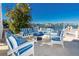 Inviting patio with blue and white striped seating, perfect for relaxing and enjoying the beautiful waterfront at 474 20Th Ave, Indian Rocks Beach, FL 33785
