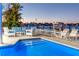 Outdoor pool and waterfront patio with cozy seating for evening relaxation and scenic water views at 474 20Th Ave, Indian Rocks Beach, FL 33785