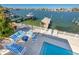 Gorgeous waterfront property with a dock and inviting outdoor seating with serene water views at 474 20Th Ave, Indian Rocks Beach, FL 33785