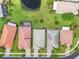 Aerial view shows well-manicured lawns, solar panels, and a pond at 5009 Sandy Brook Cir, Wimauma, FL 33598