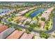 Aerial view shows lakefront community with mature landscaping and serene atmosphere at 5009 Sandy Brook Cir, Wimauma, FL 33598