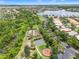 Aerial view of the community featuring a basketball court, garden, and recreation area by a lake at 5009 Sandy Brook Cir, Wimauma, FL 33598