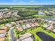Aerial view showcases the beautiful community, lakes, and lush greenery at 5009 Sandy Brook Cir, Wimauma, FL 33598
