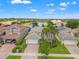 Aerial shot of home showing tile roof and a serene water view in a neighborhood with manicured lawns and trees at 5009 Sandy Brook Cir, Wimauma, FL 33598