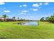 Expansive lawn and small lake in rear of property enhance the curb appeal at 5009 Sandy Brook Cir, Wimauma, FL 33598