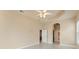 Spacious bedroom with an arched entry and tile flooring, leading to the ensuite bath at 5009 Sandy Brook Cir, Wimauma, FL 33598