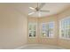 Neutral bedroom with ceiling fan and plantation shutters on multiple windows at 5009 Sandy Brook Cir, Wimauma, FL 33598