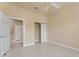Bright bedroom with tiled floors, ceiling fan, and closet at 5009 Sandy Brook Cir, Wimauma, FL 33598
