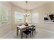 Breakfast nook with natural light, seating for four and decorative chandelier at 5009 Sandy Brook Cir, Wimauma, FL 33598