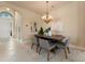 Inviting dining room with a stylish chandelier, modern decor, and access to living areas at 5009 Sandy Brook Cir, Wimauma, FL 33598