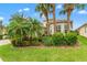 Lush landscaping, palm trees, and flowering plants accent this lovely home at 5009 Sandy Brook Cir, Wimauma, FL 33598