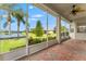 Screened lanai boasts brick floor and views of the lake and manicured lawn at 5009 Sandy Brook Cir, Wimauma, FL 33598