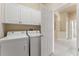 Laundry room with white cabinetry, washer, and dryer at 5009 Sandy Brook Cir, Wimauma, FL 33598