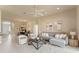 Bright living room showcasing a cozy sectional sofa, ceiling fan, and tile flooring at 5009 Sandy Brook Cir, Wimauma, FL 33598