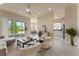Open-concept living area with views of the dining room and kitchen, and sliding doors to lanai at 5009 Sandy Brook Cir, Wimauma, FL 33598
