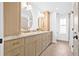 Bathroom with double vanity, two round mirrors, and gold hardware at 5120 3Rd N Ave, St Petersburg, FL 33710