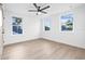 Bright bedroom with a ceiling fan and light wood floors at 5120 3Rd N Ave, St Petersburg, FL 33710