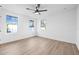 Bright, spacious bedroom with hardwood flooring, three windows, and modern ceiling fan at 5120 3Rd N Ave, St Petersburg, FL 33710