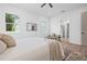 Cozy bedroom with neutral decor, light wood floors, and natural light at 5120 3Rd N Ave, St Petersburg, FL 33710