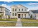 Beautiful two-story home featuring a pristine white exterior, manicured lawn, and inviting front porch seating area at 5120 3Rd N Ave, St Petersburg, FL 33710