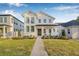 Charming two-story home with a modern white facade, lush green lawn, and a welcoming front porch at 5120 3Rd N Ave, St Petersburg, FL 33710