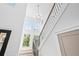 Bright foyer with a modern chandelier, staircase with black metal railings, and large windows at 5120 3Rd N Ave, St Petersburg, FL 33710