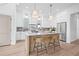 Bright kitchen featuring a center island with seating, marble countertops, and stainless steel appliances at 5120 3Rd N Ave, St Petersburg, FL 33710
