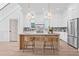 Bright kitchen featuring a center island with seating, marble countertops, and stainless steel appliances at 5120 3Rd N Ave, St Petersburg, FL 33710