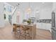 Spacious kitchen with a center island, marble countertops, stainless steel appliances, and stairway access at 5120 3Rd N Ave, St Petersburg, FL 33710