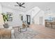 Spacious living area featuring high ceilings, modern decor, hardwood floors, and access to the staircase and kitchen at 5120 3Rd N Ave, St Petersburg, FL 33710